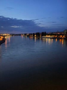 the Rhine river at night with lights from the city